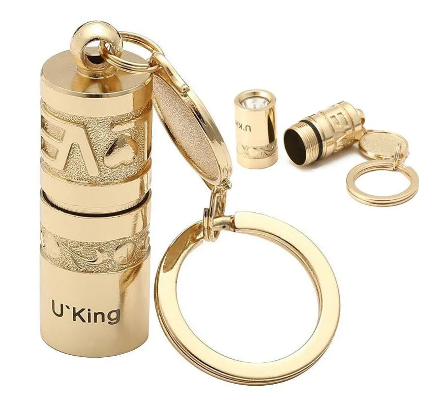 Gold zinc alloy waterproof LED flashlight attached to keychain with compact portable design