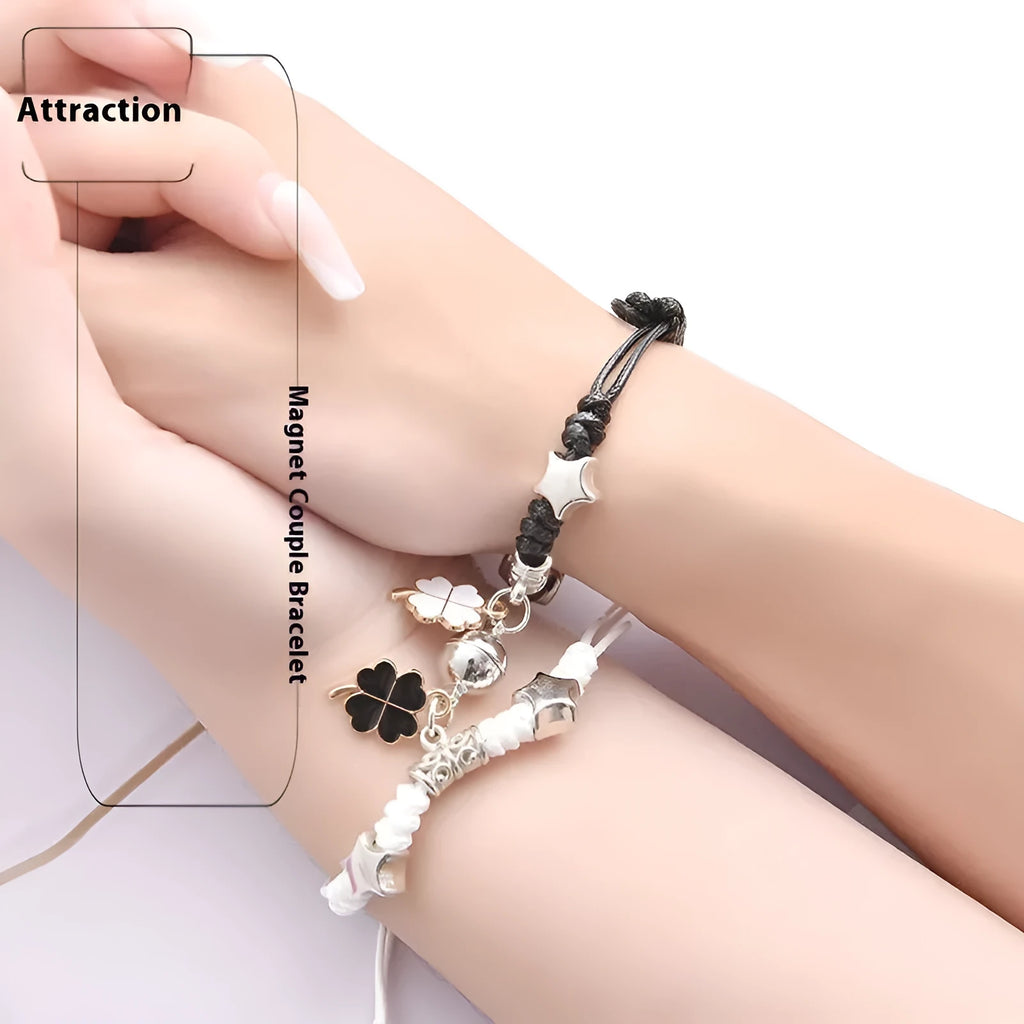Pair of magnet couple bracelets with suction clasp on wrist, showing alloy designs like crown and love lock.