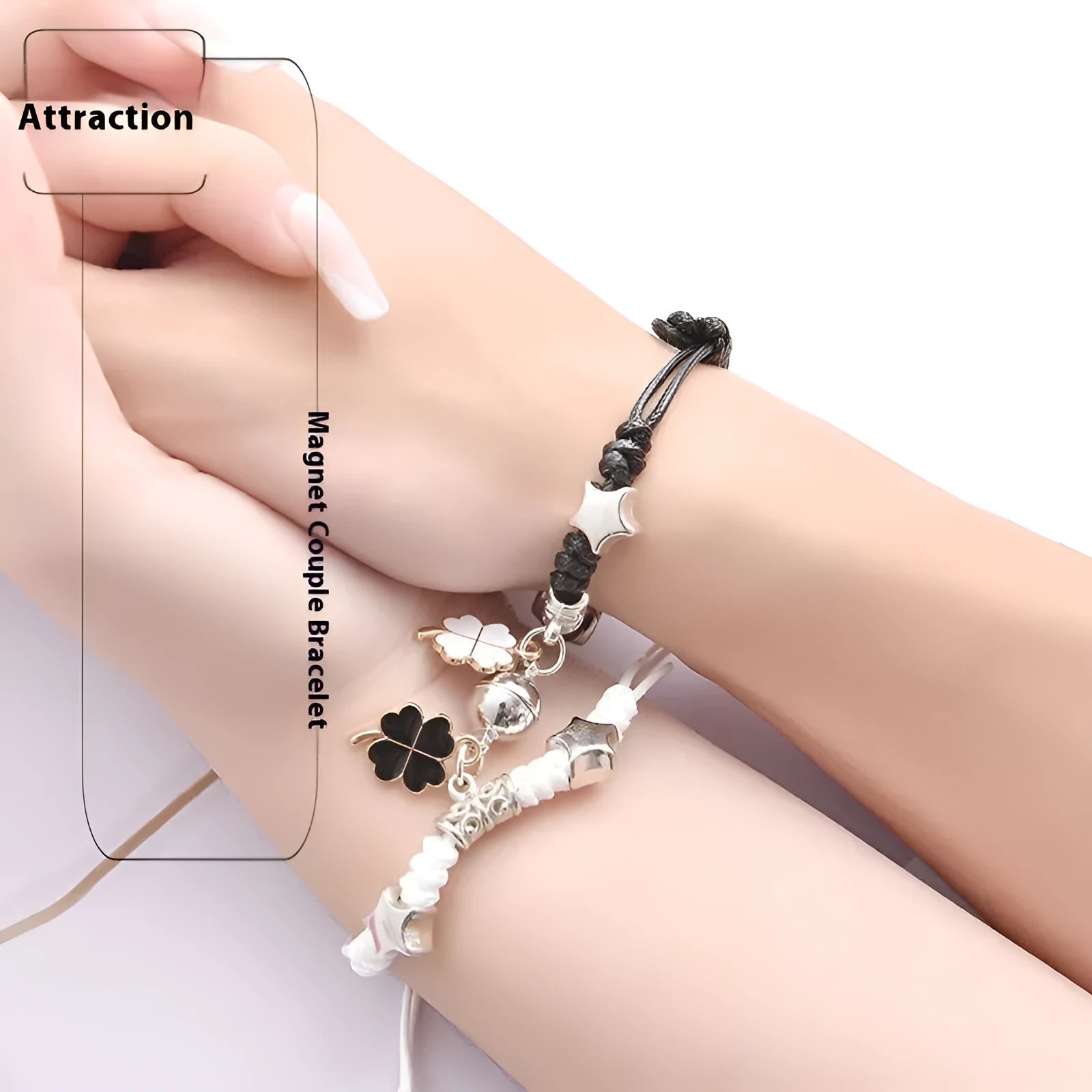 Pair of magnet couple bracelets with suction clasp on wrist, showing alloy designs like crown and love lock.