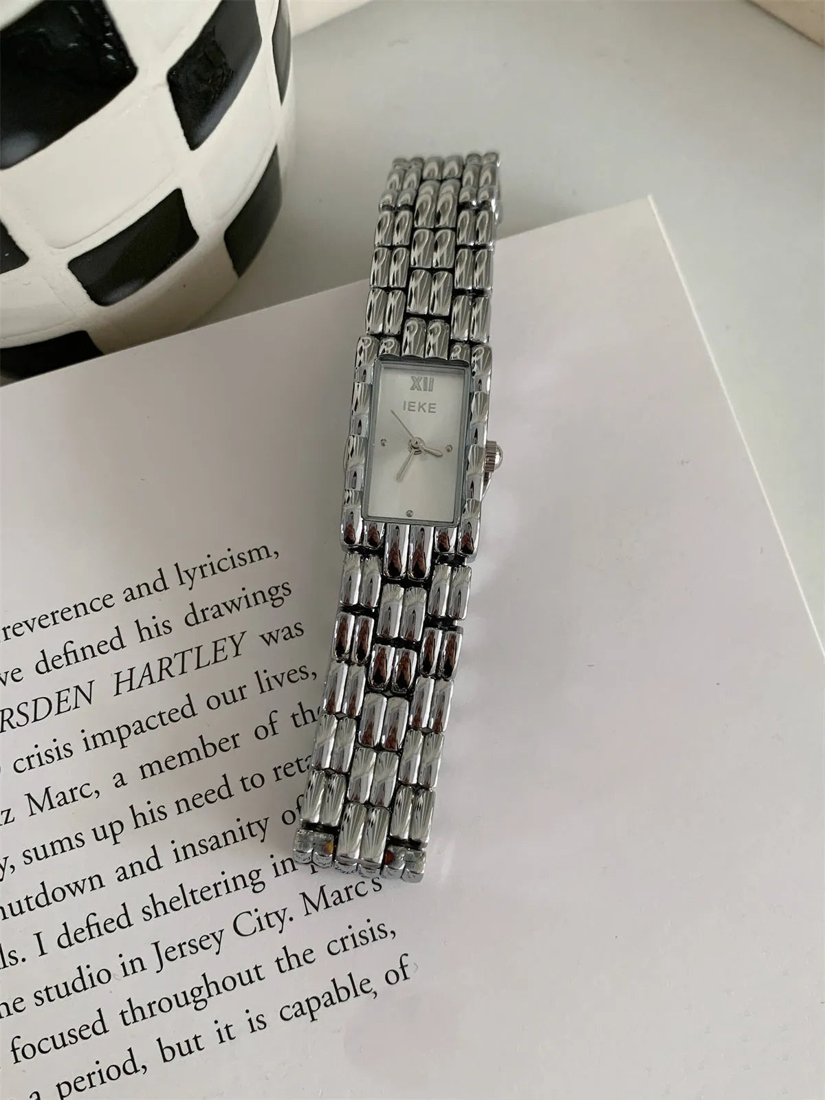 Women's silver and gold bracelet-style vintage watch with 15mm dial on wrist