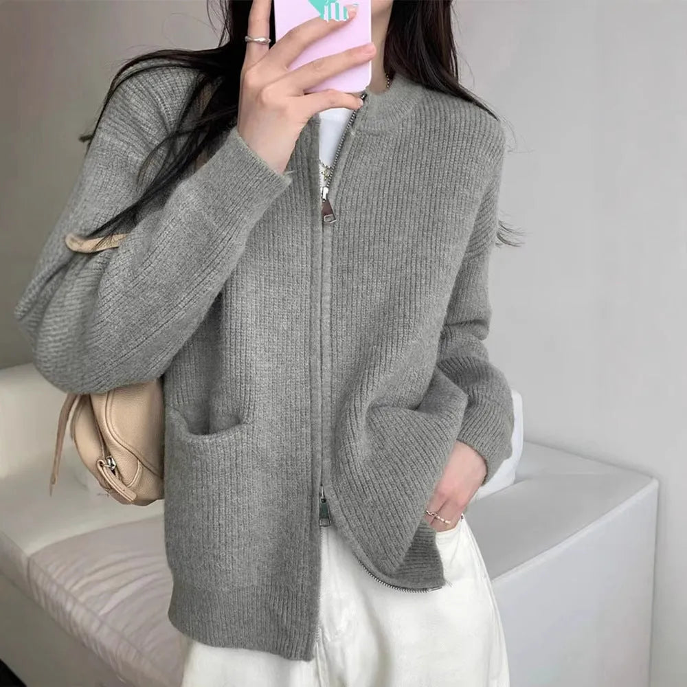 Beige soft viscose knit cardigan with long sleeves shown on a hanger.