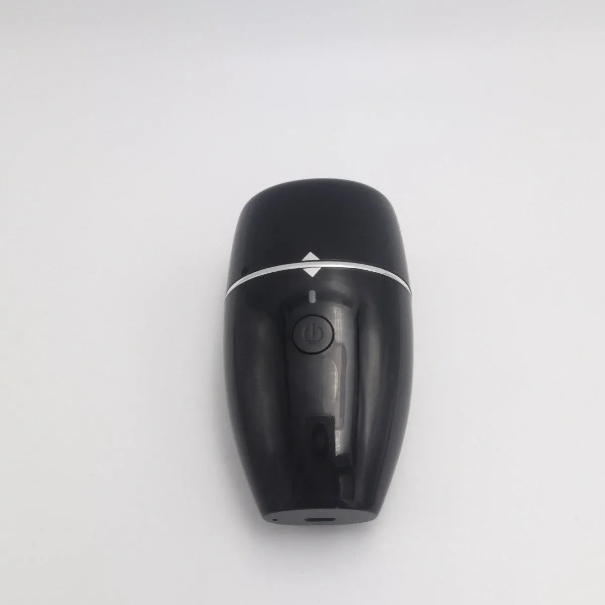 Black electric lip plumper device with a silicone tip next to a white USB charging cable.