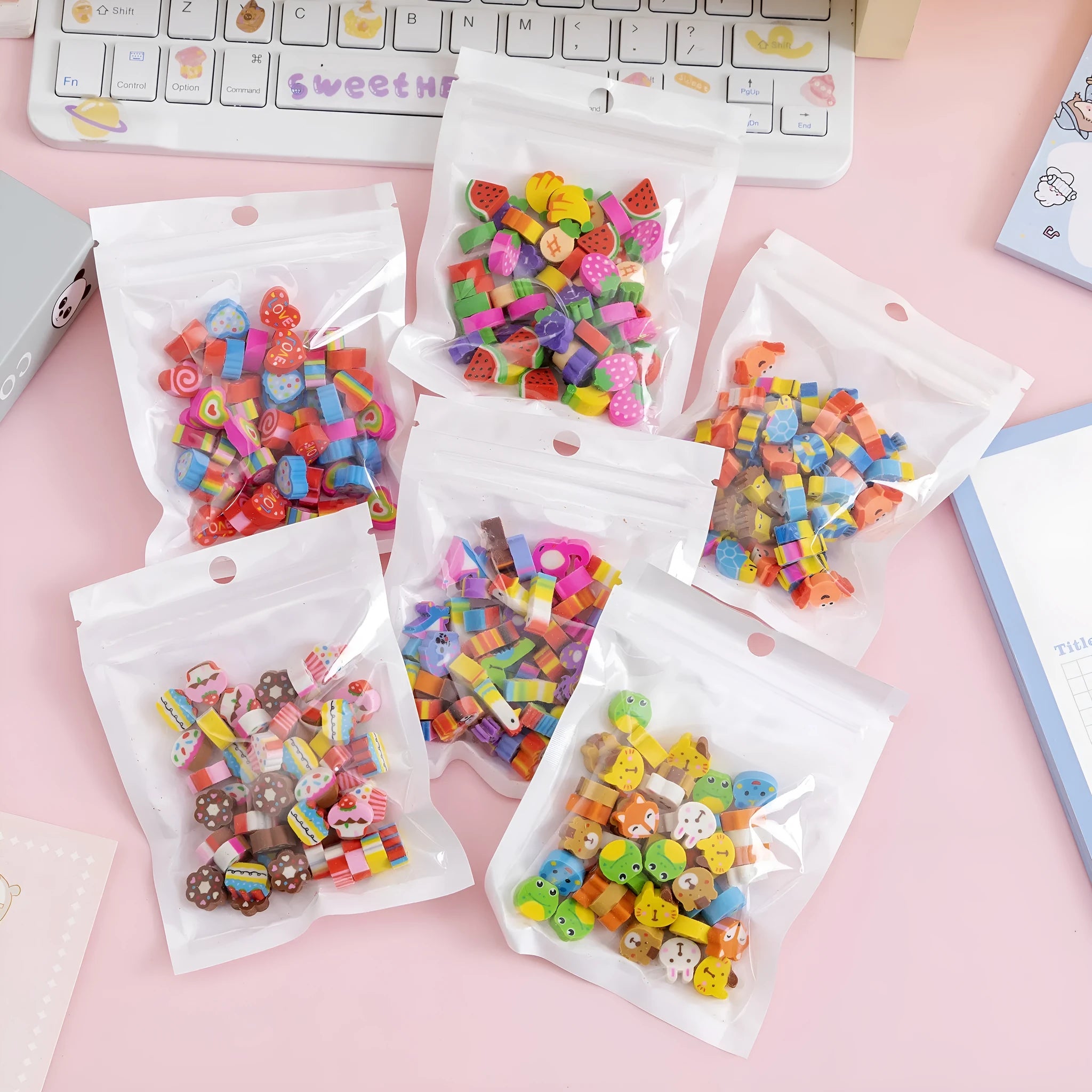Assortment of 50 colourful cartoon mini erasers including fruits, animals, and themed shapes on a white background.