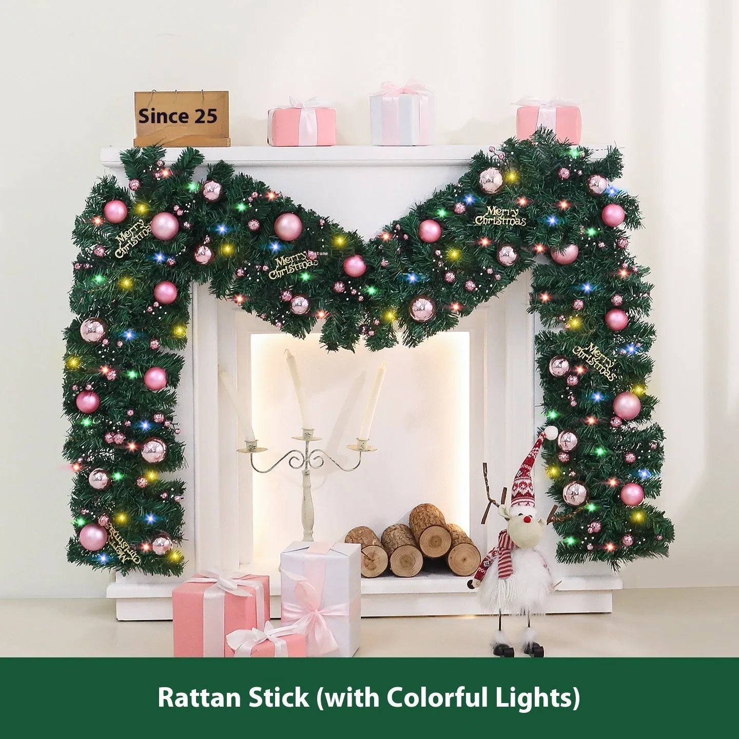 Pink artificial rattan Christmas garland with small fruit details and warm white LED lights, coiled to show its 2.7m length.