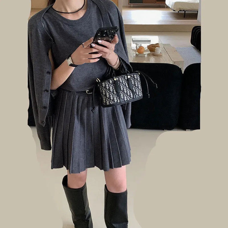 Women's grey vest skirt and cardigan two-piece set with belt and pleated details