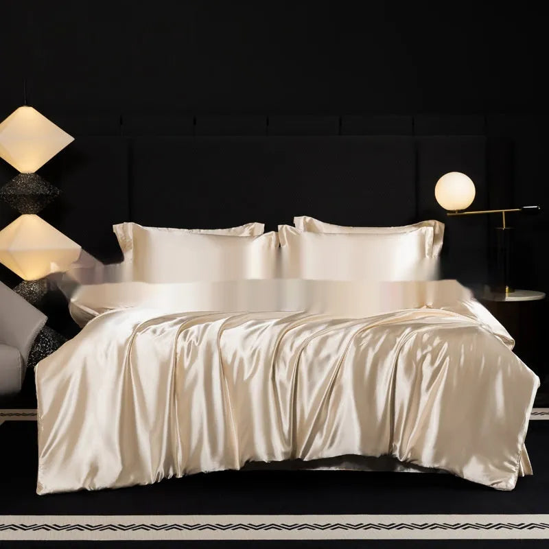 Solid colour silk bedding four-piece set shown in twilight blue on a bed.