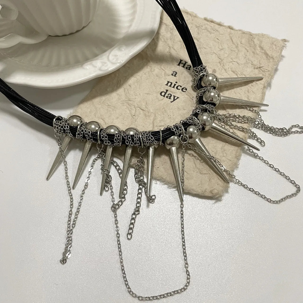 Genuine leather tassel necklace with electroplated rivet details and round beads