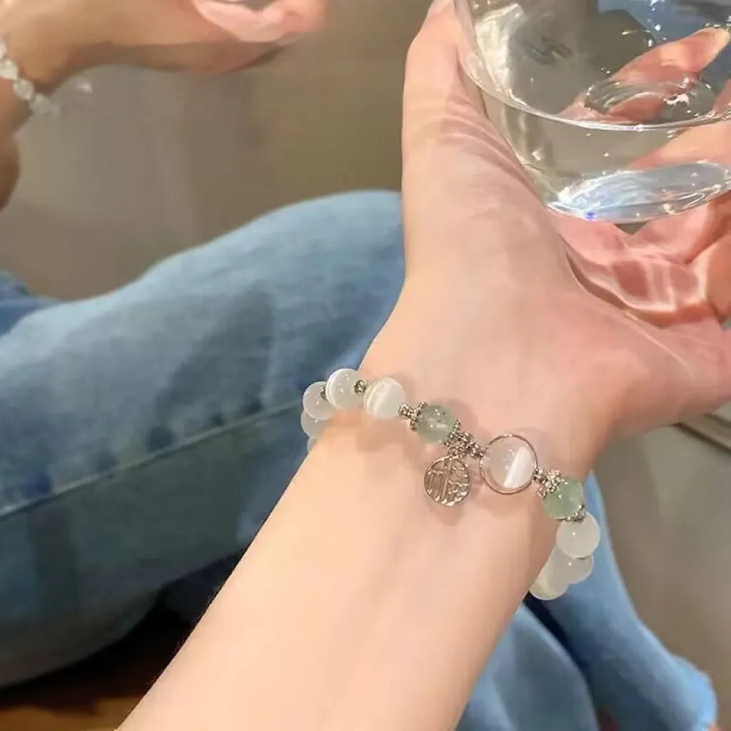 Handmade glass butterfly charm bracelet for women in a drop shape with round details.