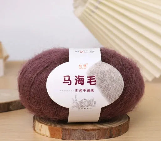 DIY mohair scarf weaving kit showing one wool ball and a selection of 34 colour options including white, pink, blue and green.
