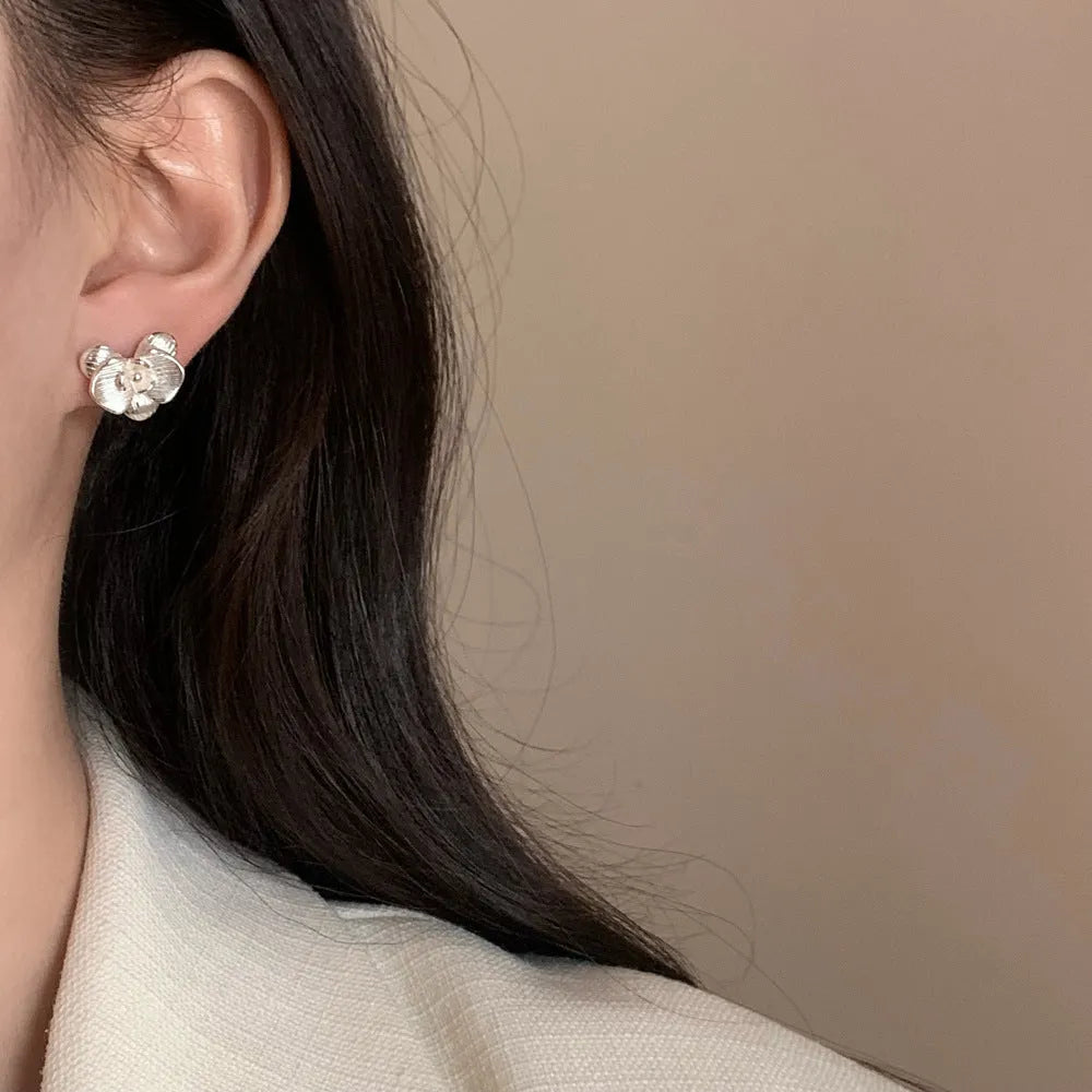 Retro flower fashion earrings in gold or silver electroplated finish with petal details