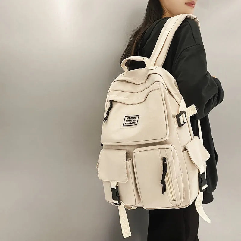 Soft nylon student backpack in black or white with computer compartment and three-dimensional pockets