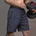 Men's loose fit sports shorts in polyester with elastic waistband available in black, grey and blue colours