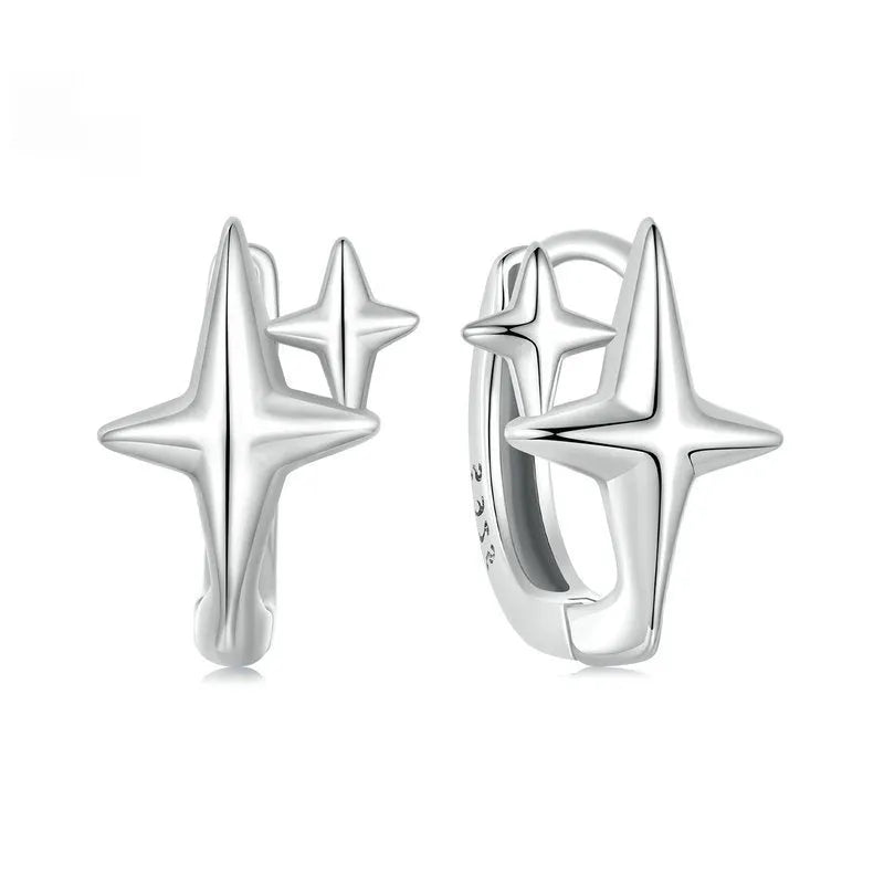 Minimalist sterling silver star clip earrings with oxidation treatment and XINGX celestial elements