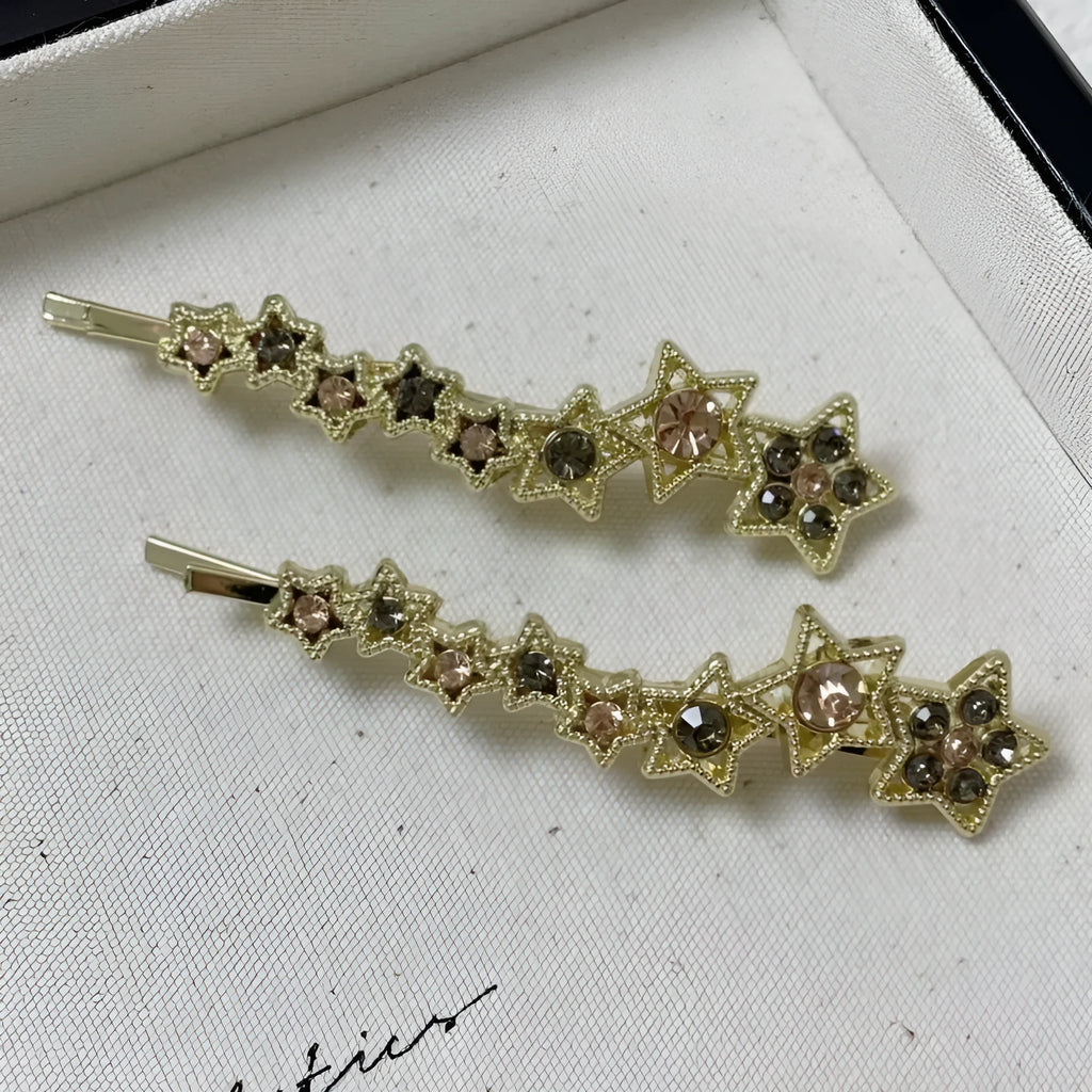 Gold hair barrette clip with rhinestone star detail on side