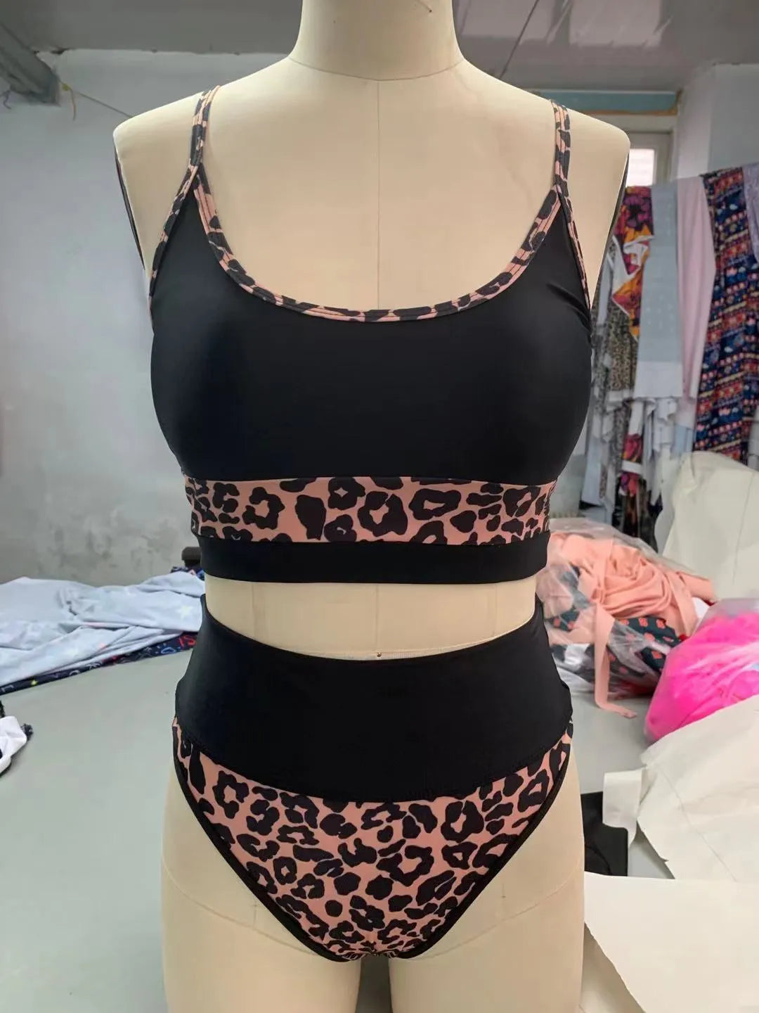 Women's white and leopard print high-waist bikini swimsuit set on a mannequin.
