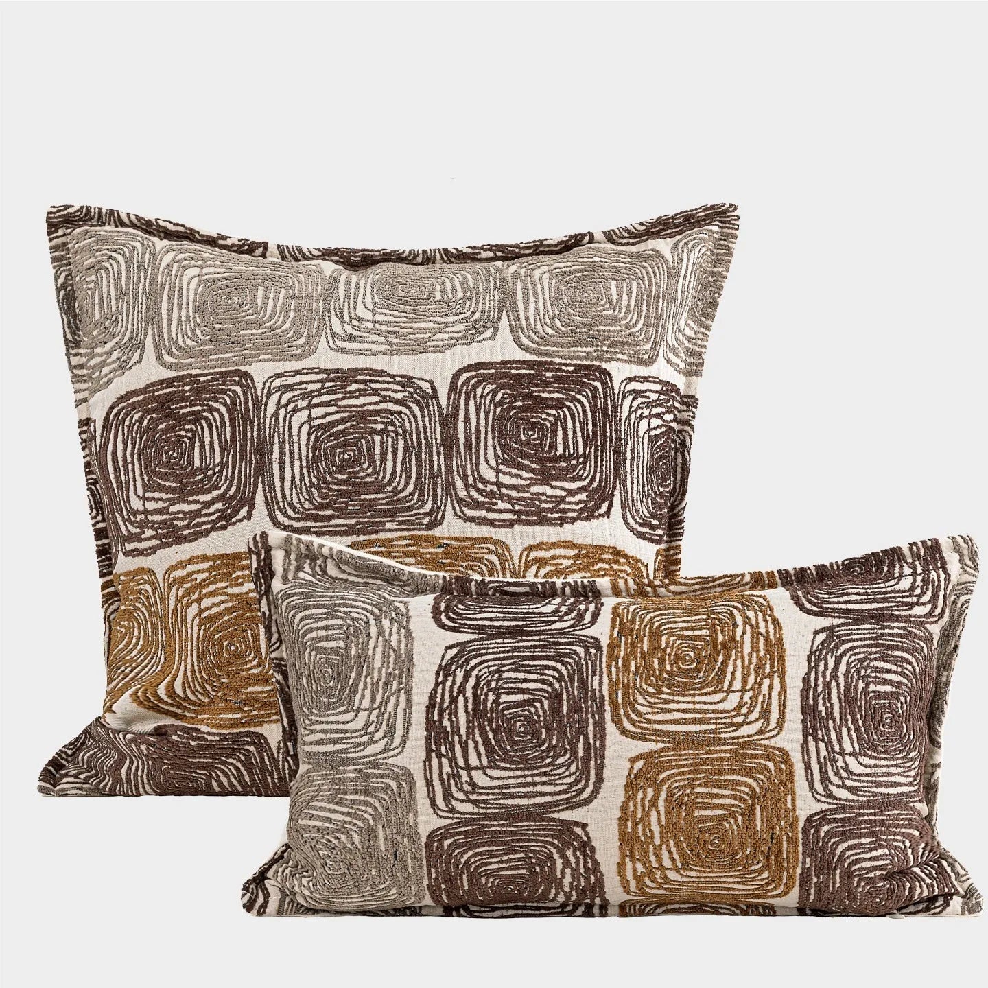 Cream and coffee-coloured abstract coil pattern on square and rectangular polyester pillow covers.