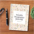 A5 pregnancy weekly diary notebook open showing weekly tracking pages