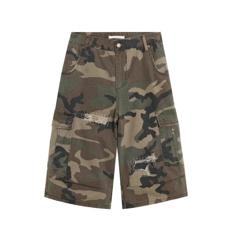 Men's camouflage cropped jeans with patchwork detailing and distressed rips in loose straight-leg fit