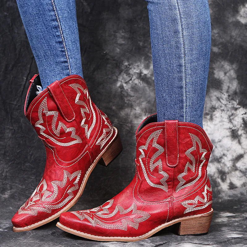 Women's blue embroidered cowboy boots with a low wedge heel and pointed toe.