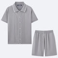 Man wearing a khaki short-sleeve knit top and matching shorts from a business casual two-piece set