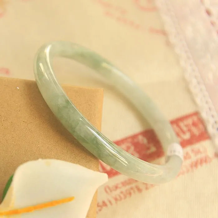 Green jade geometric bracelet with waxy finish showing 10mm width and adjustable sizing