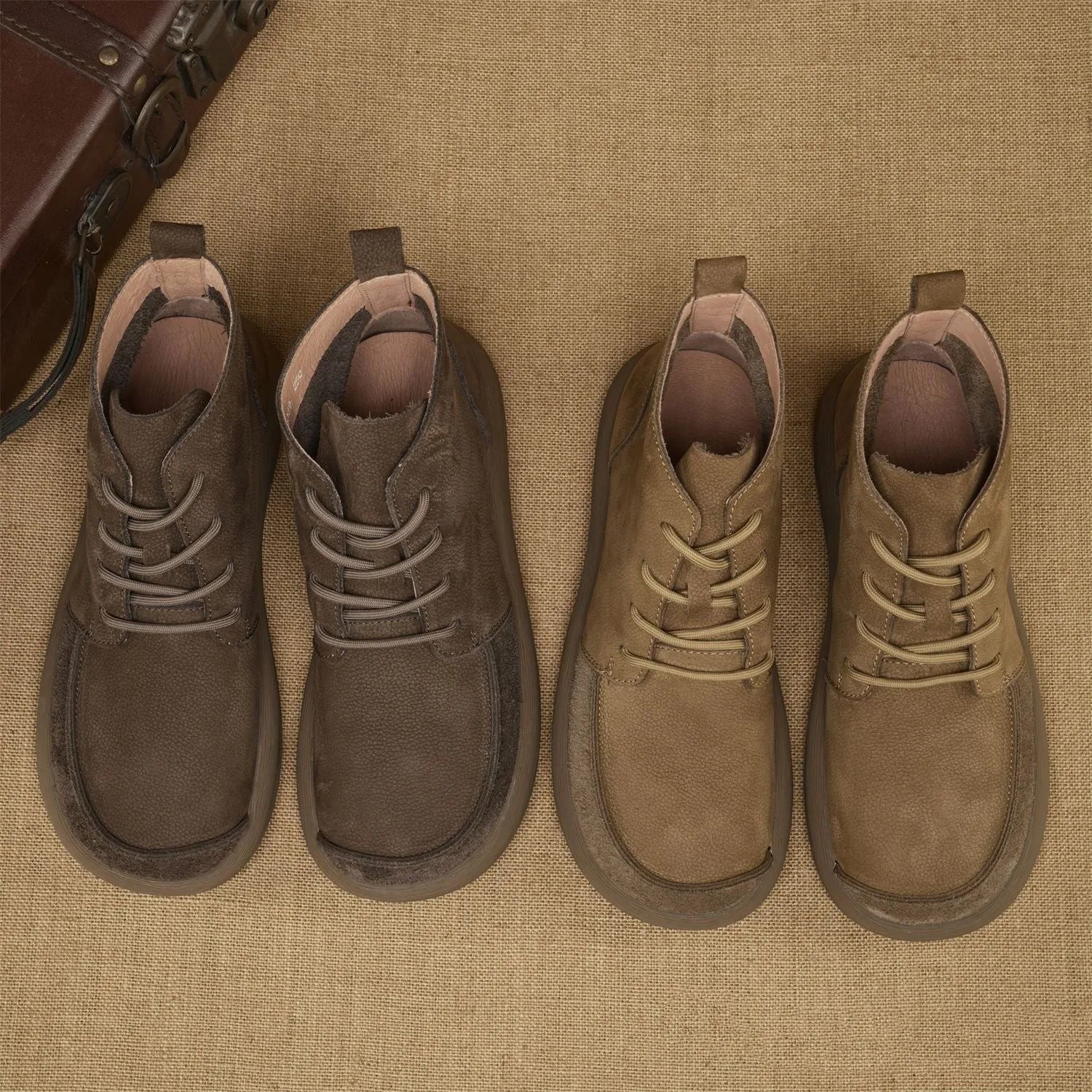 Grey genuine leather martin boots with wedge heel and front lace-up fastening on a neutral background