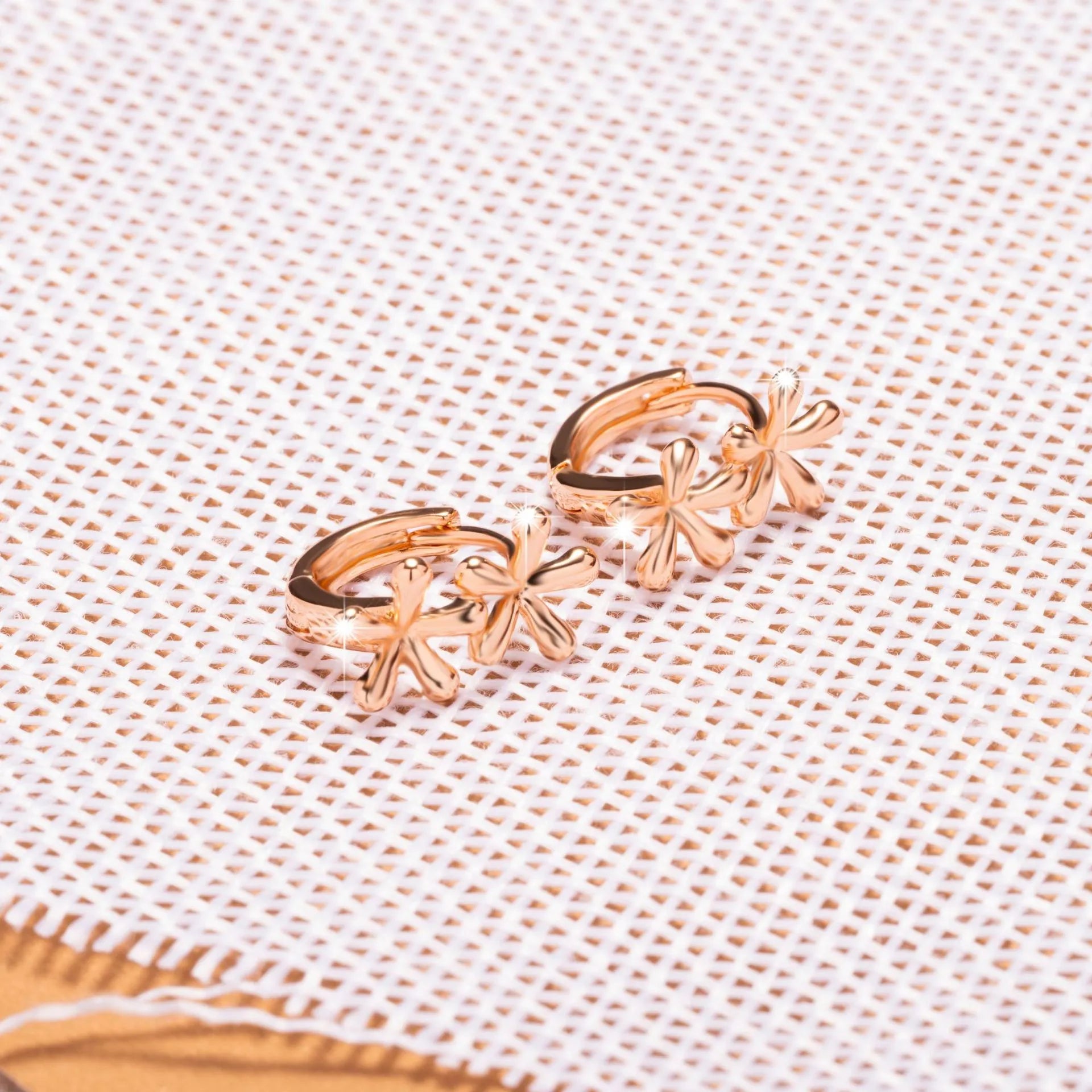 Circular rose gold earrings with a waterdrop flower design for women.