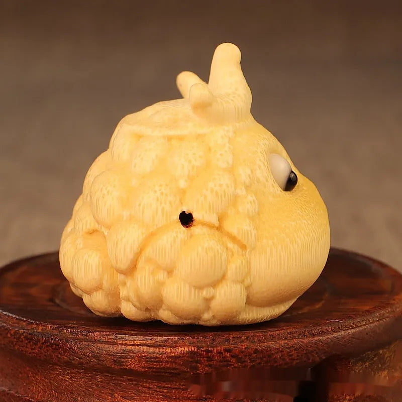Close-up of a 5 cm cute Crown Princess Toad ornament carved from solid bamboo.