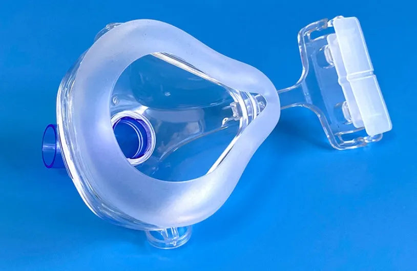 Transparent CPAP breathing mask with silicone cushion and adapter elbows for ventilator connection