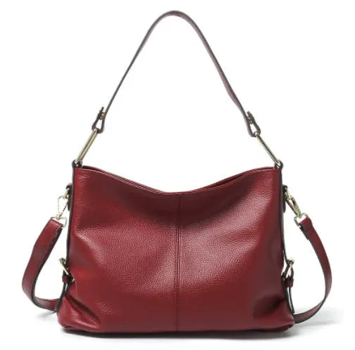 Square vertical genuine leather crossbody bag with multiple internal zipper compartments.