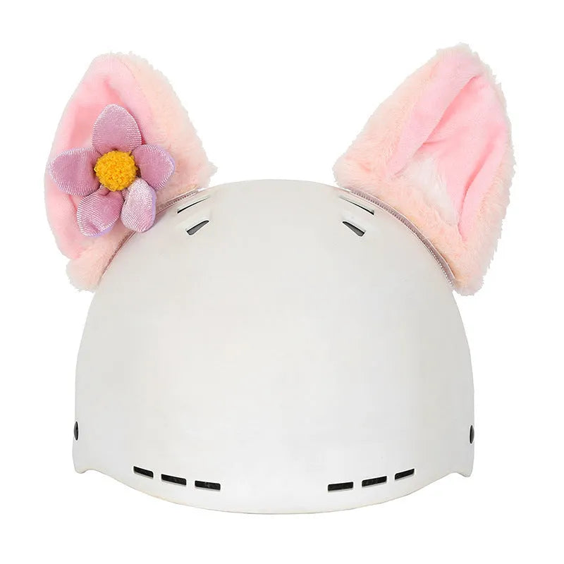 Plush fabric ski helmet decoration with cartoon design on a black ski helmet.