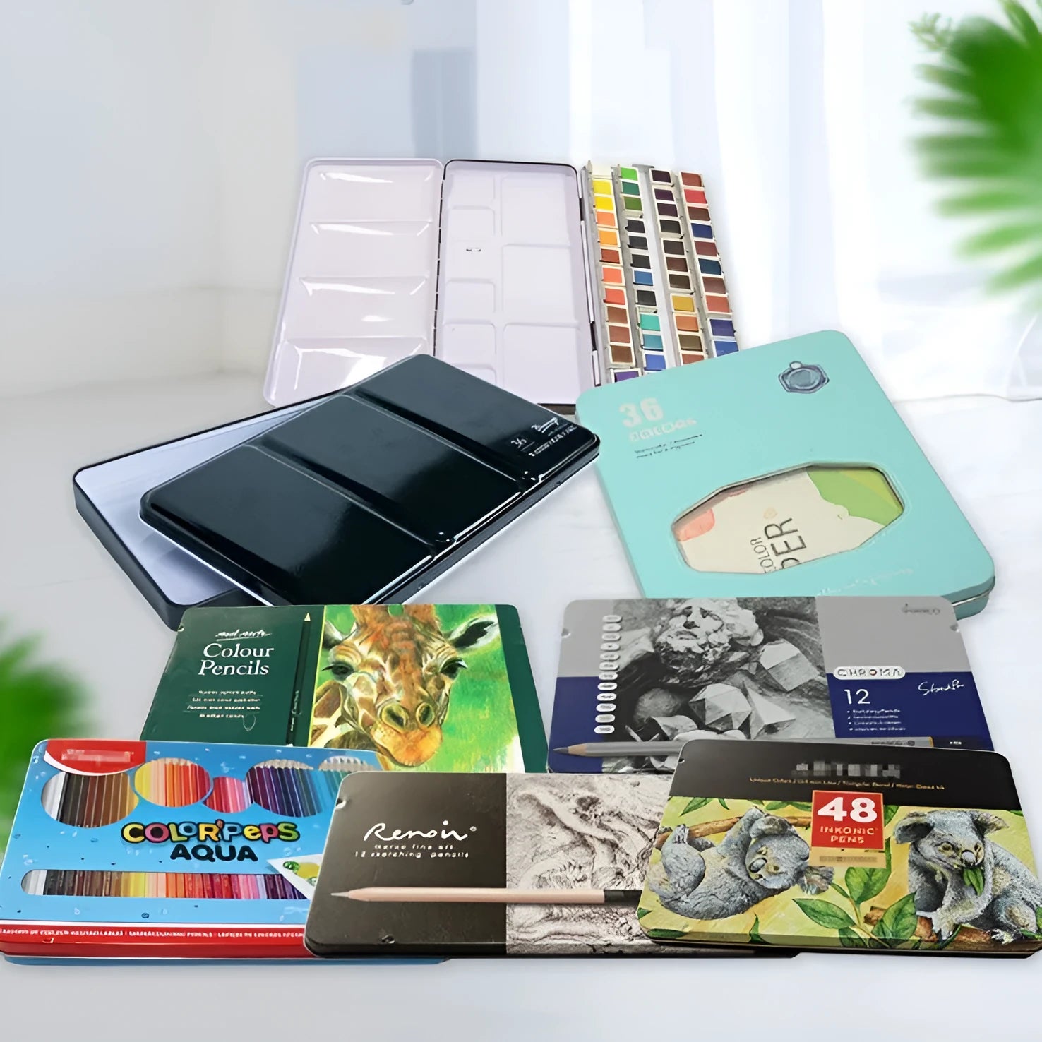 Square tinplate metal paint box for solid watercolour pigments in three folding sizes.