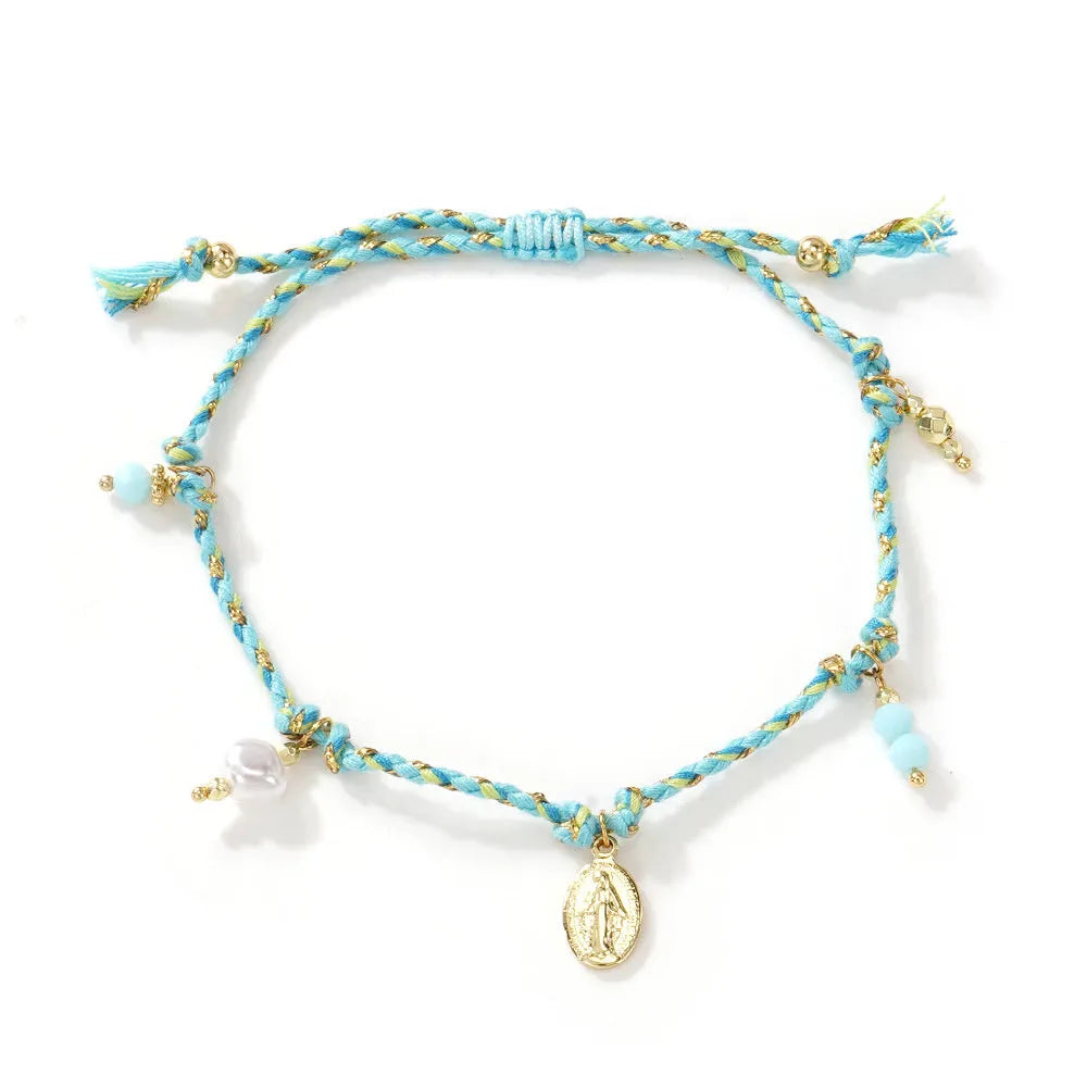 Close-up of a hand-woven colourful braided rope bracelet with an adjustable strap tag closure.