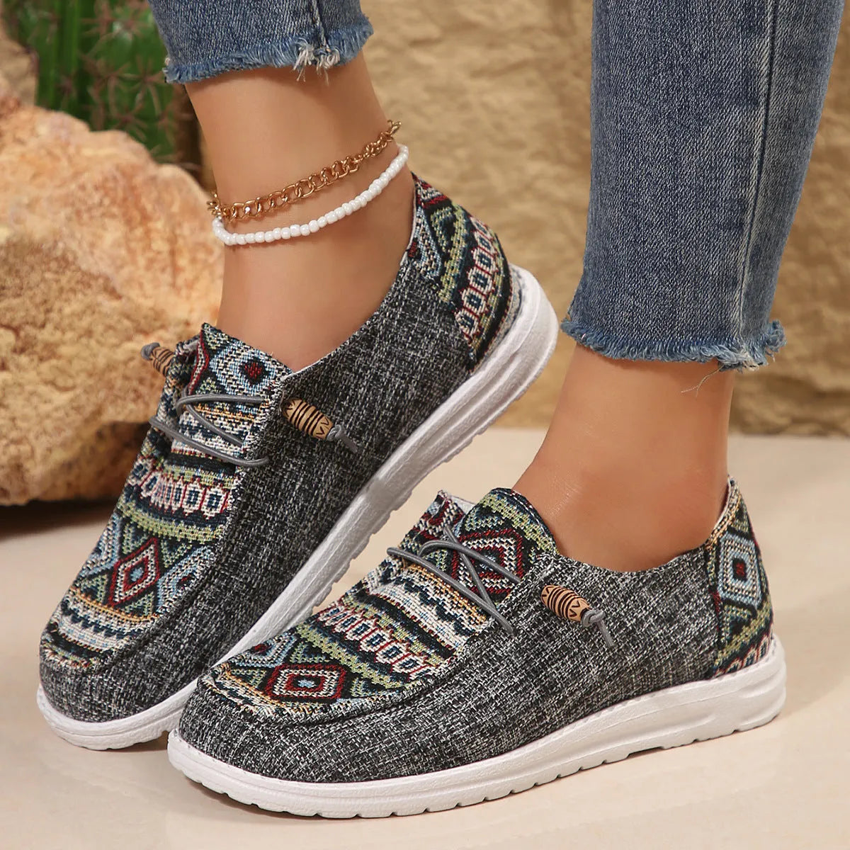 Women's black slip-on flat shoes with round toe and rubber sole on a plain background