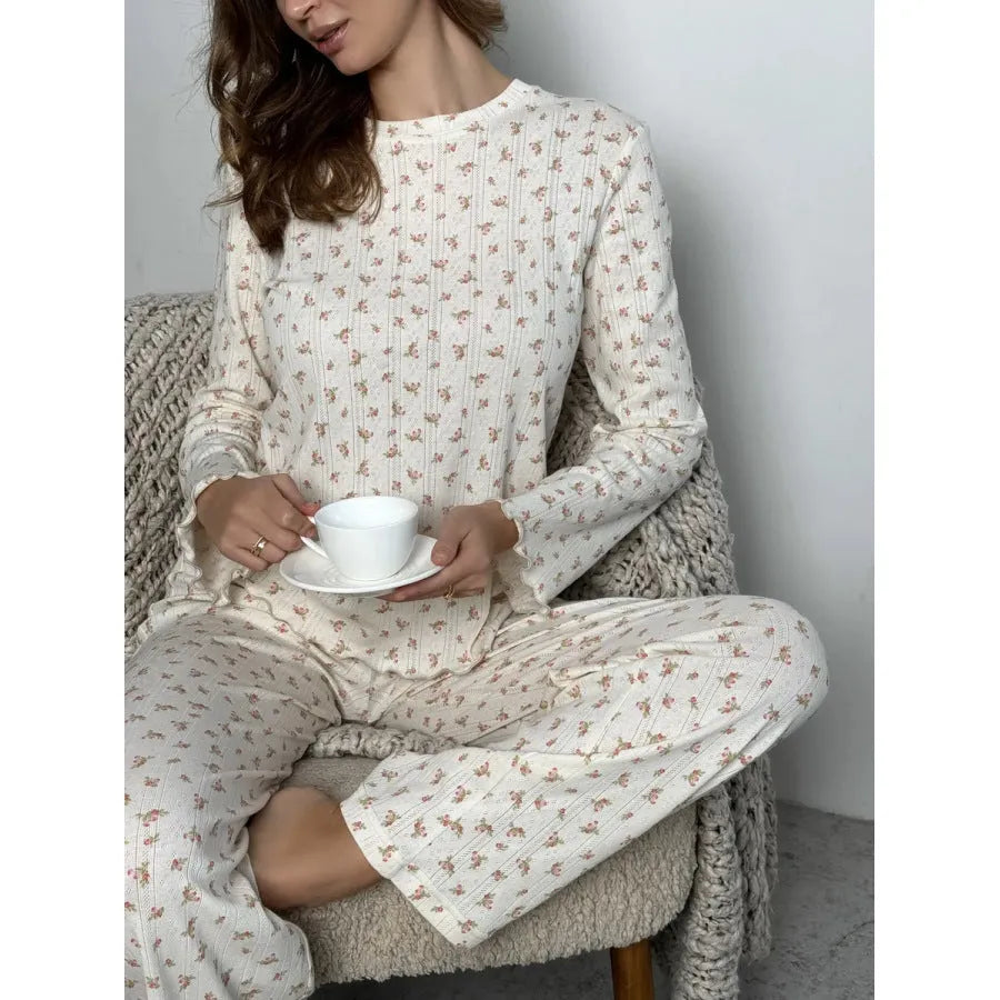 White floral print women's bell sleeve top and wide leg trousers suit on hanger