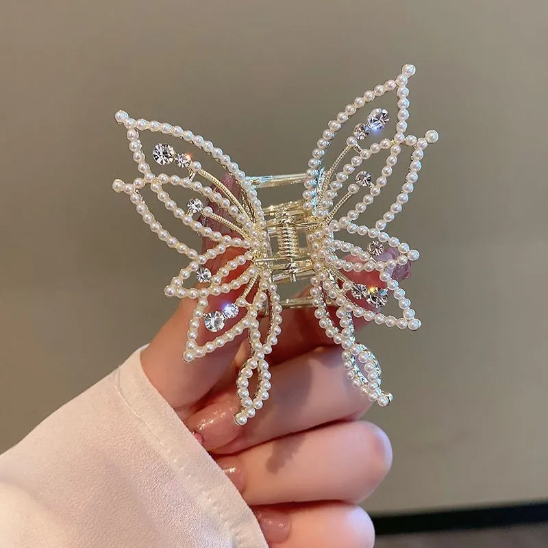 Butterfly-shaped alloy hair clip barrette for women, shown in rhinestone and pearl style options.
