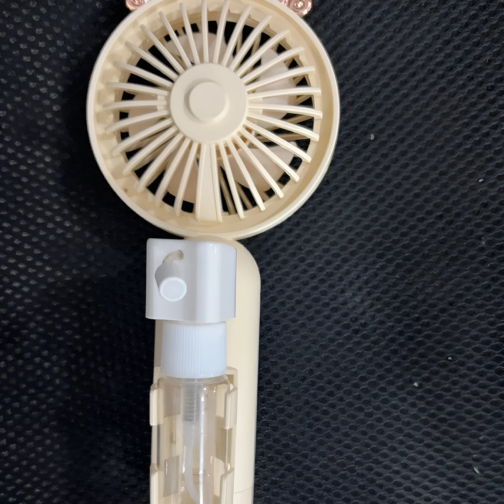 USB-powered personal handheld fan in apricot colour with plastic nozzle