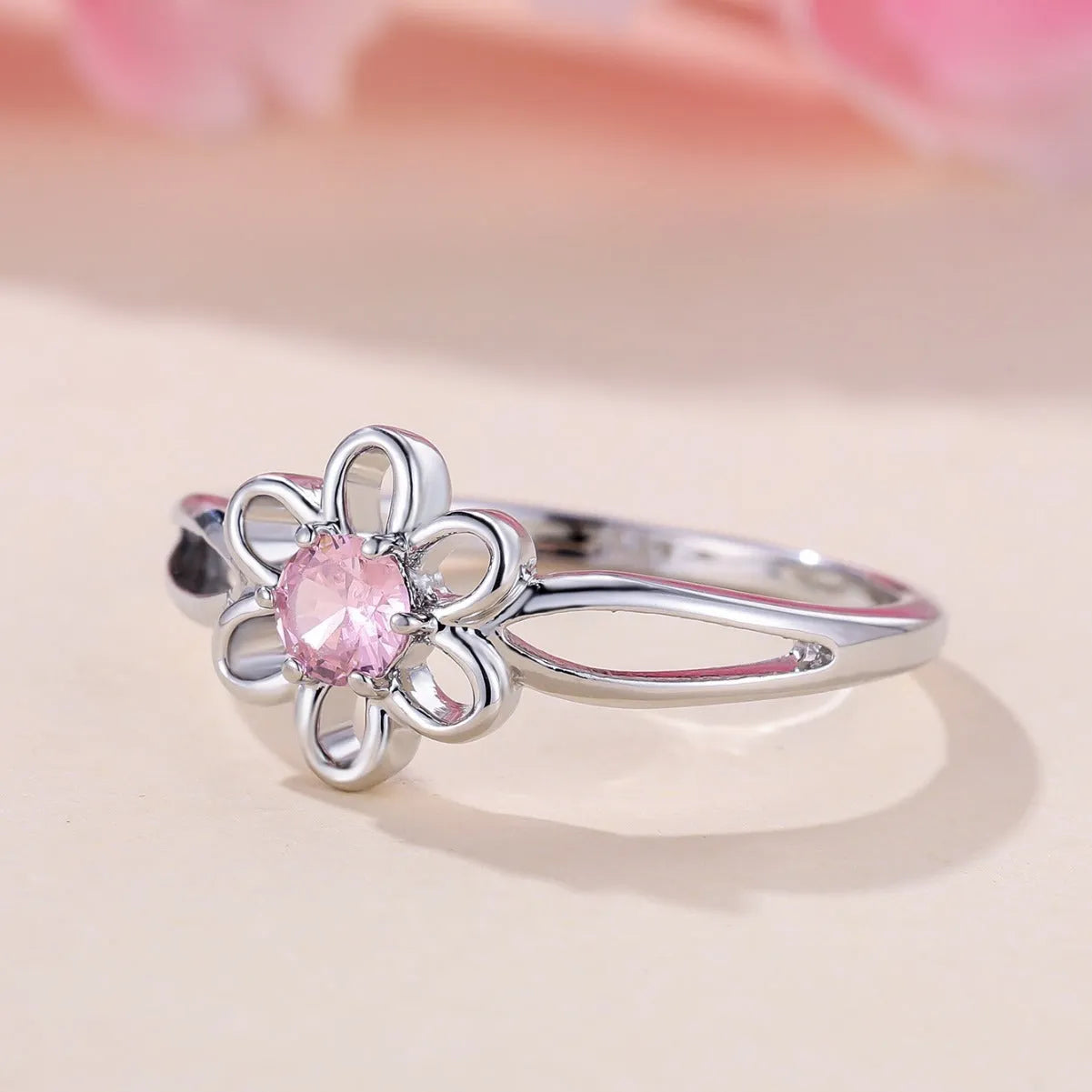 Copper flower hollow-out fashion ring for women with platinum pink diamond plating.