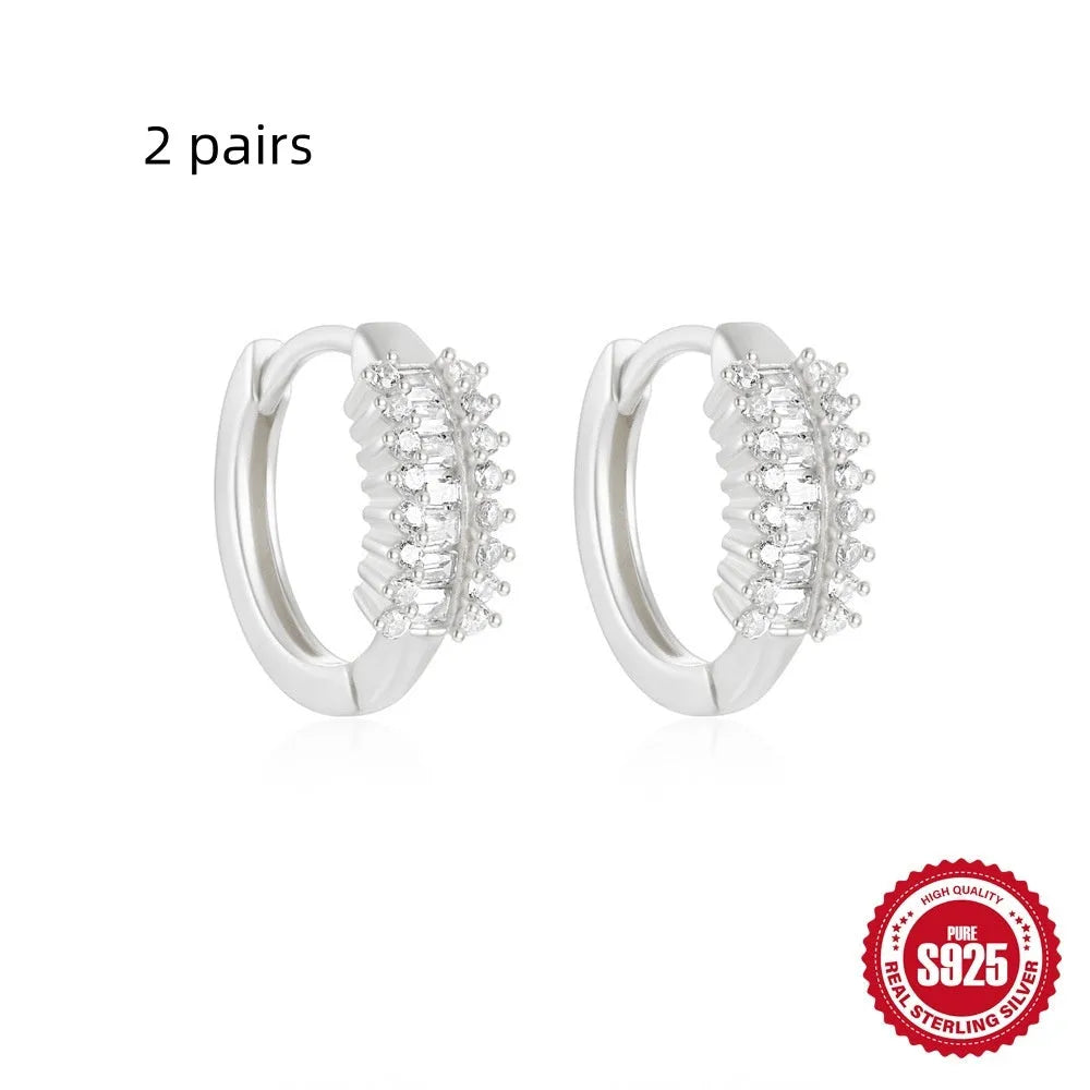 Small round geometric sterling silver stud earrings with a diamond shape, available in gold or silver finish.