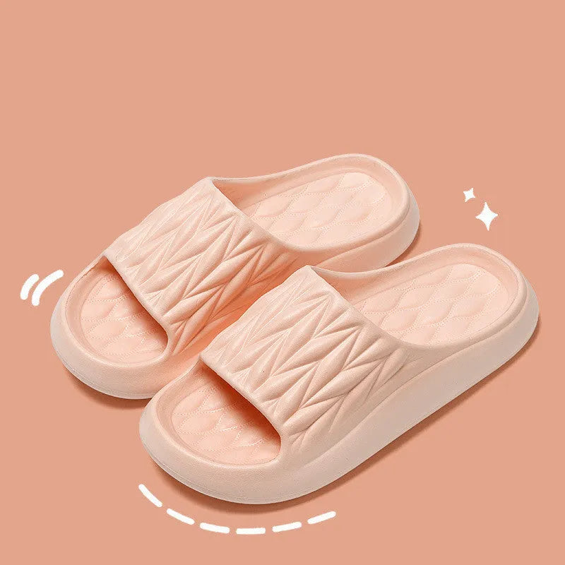 Pair of leaf-textured EVA indoor slippers on a solid background, showing non-slip sole.