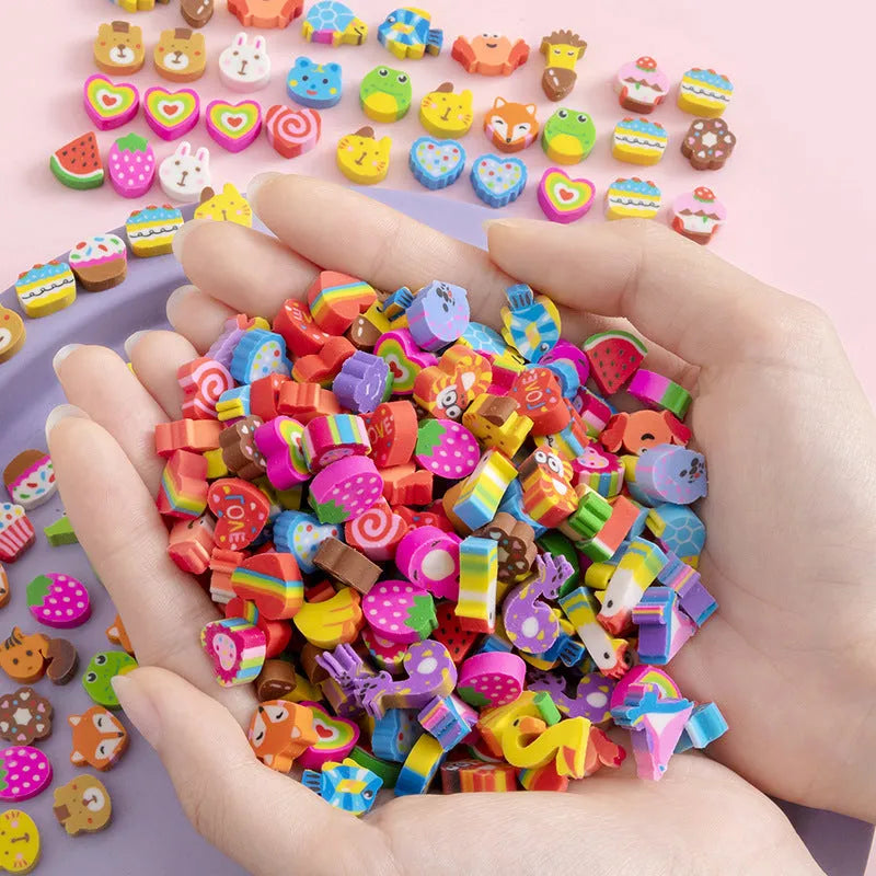 Assortment of 50 colourful cartoon mini erasers including fruits, animals, and themed shapes on a white background.