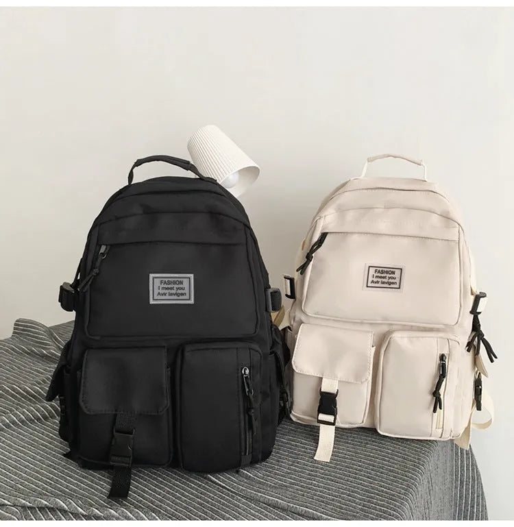 Soft nylon student backpack in black or white with computer compartment and three-dimensional pockets