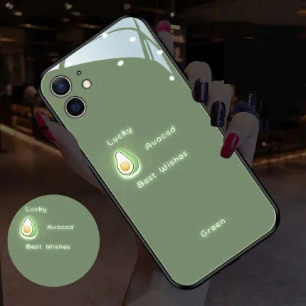 White luminous iPhone case with purple daisy design and voice-activated colour light on a table.