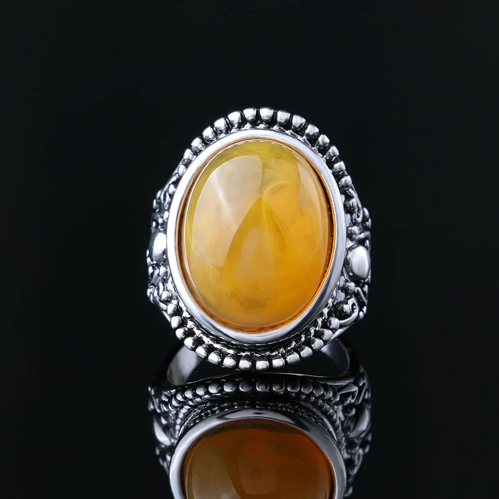 Geometric antique silver amber alloy ring with retro design on a hand.