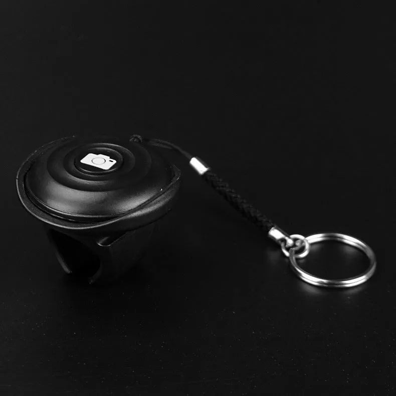 Black Bluetooth selfie remote control with snap button for wireless smartphone camera triggering
