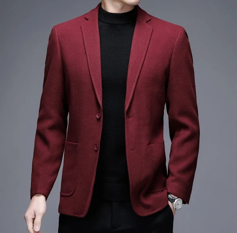 Men's loose fit wool suit jacket in solid colour showing round hem design and long sleeves