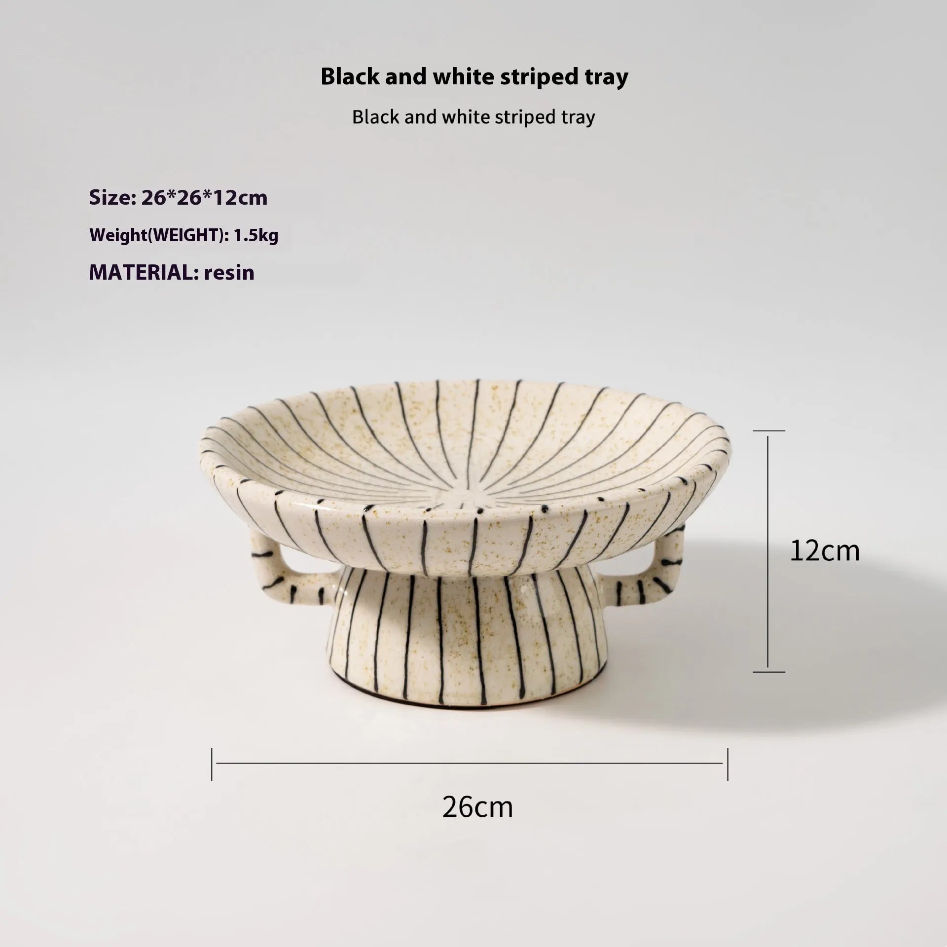 Black and white striped retro-style resin fruit or dessert plate on a table.