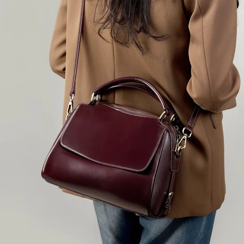Genuine leather crossbody tote bag in a cross square shape with double straps and internal organiser pockets.