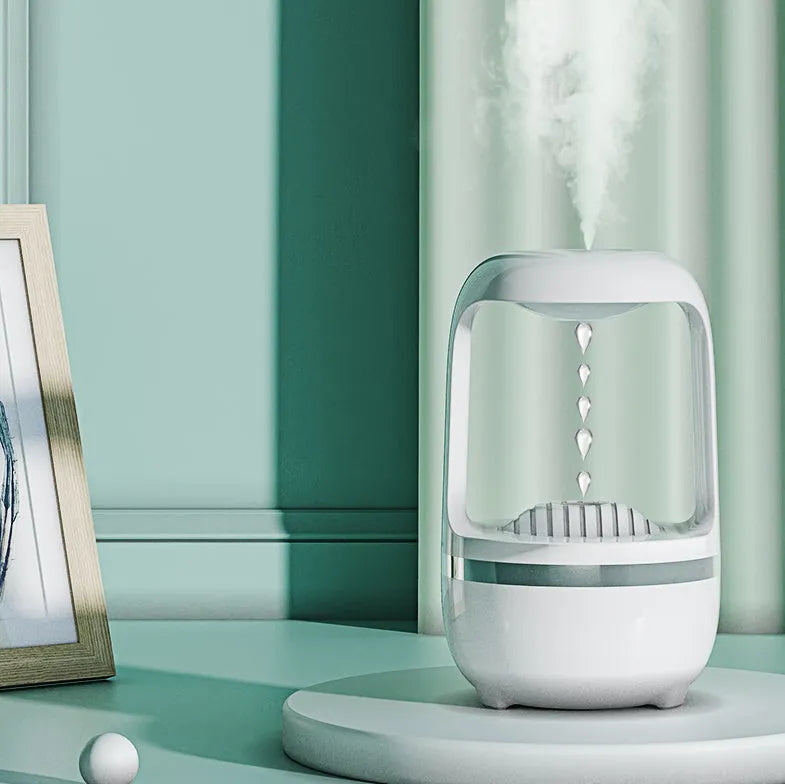 White anti-gravity water droplet humidifier with aromatherapy function on a desk.