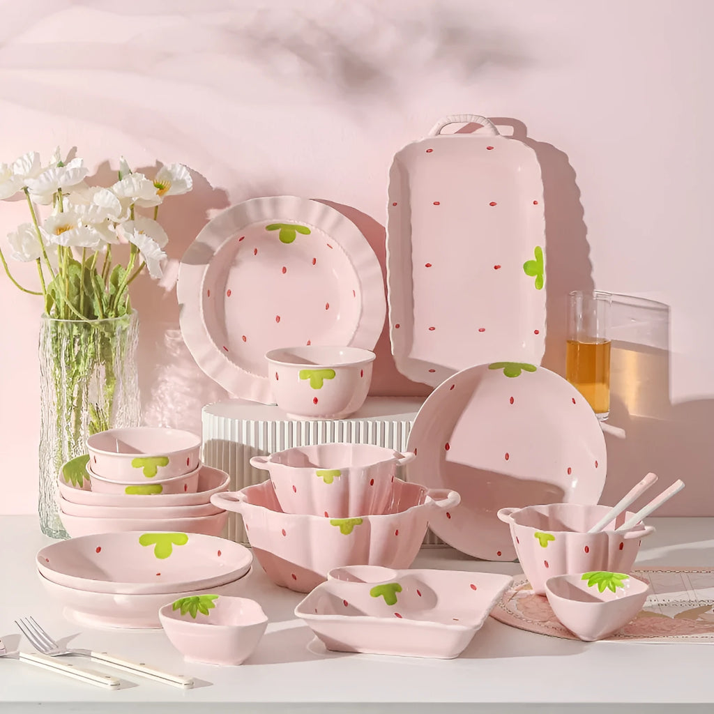 Porcelain dinnerware set with strawberry design showing plates, flower bowls, and twist spoon
